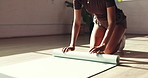 Woman, hands and roll with yoga mat on floor for done activity or finished exercise in home. Active, female person or yogi with completion or packing up for fitness, health or wellness in house