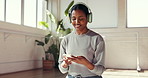 Woman, headphones and phone in pilates class for social media, podcast or typing on fitness app. Smile, female person or yogi on smartphone for online chatting, texting and music break for yoga blog