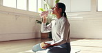 Drinking water, fitness and yoga with Indian woman in studio for health, exercise or wellness. Break, hydration and recovery with thirsty yogi person in class for healing, holistic routine or pilates