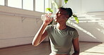 Break, drinking water and yoga with black woman in studio for health, exercise or wellness. Fitness, hydration and recovery with thirsty yogi person in class for healing, holistic routine or pilates