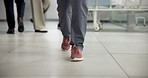 Walking, corridor and feet of doctor in hospital for treatment, medical service and operation. Healthcare, surgeon and shoes of person in clinic for surgery prep, wellness and emergency in lobby