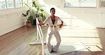 Ballet, pole and stretching with woman in studio for theater practice, recital or rehearsal. Balance, equipment and warm up with ballerina in dance class for artistic expression or preparation