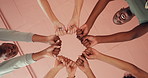 Hands, fist and group for motivation, below and power for exercise, friends o smile at fitness club. People, women and team with celebration, solidarity or goals for happy for wellness at class