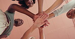 Huddle, motivation and stack of hands with women in studio together for health, wellness or yoga from below. Fitness, palm and solidarity with group of friends in circle for support or team building