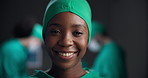 Woman, surgeon and happy with face in emergency room with pride for medical services at hospital. Person, doctor and portrait with smile, scrubs and healthcare professional with career at clinic