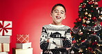 Studio, face and child with smile, christmas or excited for festive season, arms crossed or holiday. Red background, confident and boy with Xmas sweater, December and happy for celebration in USA