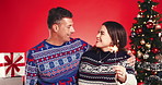 Christmas, hug and sparkler with couple in studio together for bonding and gift or present. Love, celebration or smile with man and woman embracing on red background for festive tradition or holidays