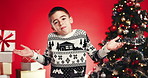 Christmas, confused and boy in studio for thinking, tradition and shrug on red background. Xmas, holiday season and child with presents, unsure and decision with idea, choice and decide for gifts