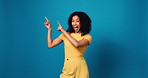 Studio, face and woman with smile, pointing and presentation for discount offer, mockup space or ad. Blue background, happy and person with gesture for announcement, suggestion or excited with news