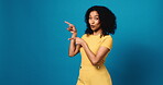 Studio, face and woman with presentation, pointing and smile for discount offer, mockup space or ad. Blue background, happy and person with gesture for announcement, suggestion or excited with news