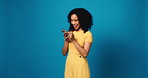 Woman, phone and excited with laugh in studio, notification and scroll with funny video on blue background. Girl, smartphone and mockup space with smile for meme, mobile app and happy on social media