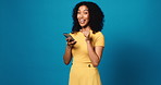 Woman, face and phone with surprise in studio, announcement or mockup space on blue background. Girl, wow and promotion with point, giveaway or discount deal with online shopping app in Costa Rica
