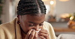 Cold, sick and black woman blowing nose in home, allergies and virus infection with winter blanket. Tissue, wipe and person in living room with flu, health problem and disease with bacteria risk