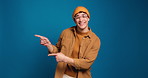Happy man, face pr pointing with fashion in studio for marketing or option on a blue background. Portrait, male person or model with smile or showing list for selection or advertising on mockup space