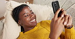 Above, smartphone and black woman on sofa, smile and relax with social media, funny meme and home. African person, apartment and cellphone with connection, laugh or online comedy with app or internet