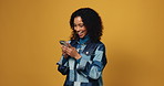 Woman, smartphone and happy with laugh in studio, notification and funny video on yellow background. Girl, phone and scroll on mobile app with mockup space, meme and chat with smile on social media