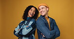 Fashion, laughing and face of friends in studio for confidence, smile and support together. Happiness, trendy style and partner with man and woman on yellow background space for joke, pride and cool