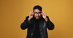 Happy man, check glasses and face in studio for optometry, prescription lens or squint on yellow background. Person, spectacles and portrait with mockup space, vision or healthy eyesight in Thailand