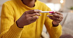 Woman, hands or home with pregnancy test for results, motherhood or conception exam on sofa. Closeup, female person or reading with maternity stick or check for medical diagnosis, DNA or IVF in house
