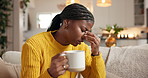 Coffee, pain and black woman in home with headache, sick or burnout with tea beverage. Drink, migraine or person with stress on sofa for tension, tired or overwhelmed with brain fog for mental health