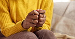 Hands, stress and fidget on sofa in home with anxiety, worry and insight for decision in living room. Person, fingers and mental health on couch, doubt or frustrated for choice in lounge at apartment