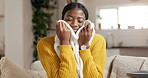 Home, aroma and black woman on sofa, folding laundry and satisfied in living room. Happiness, housekeeping and African person on couch, fabric scent and clean clothing with maintenance or fresh smell