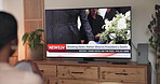 Person, watching tv and screen for news update with back for head state funeral, casket and headlines at home. Television, broadcast and monitor for program, report and memorial show for president