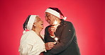 Senior, happy couple and studio with fireworks for christmas celebration on a red background. Elderly, man and woman with hug, embrace or sparklers for festive, december holiday or love on space