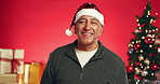 Laughing, Christmas and face of old man in studio for holiday season, retirement and smile. Festive celebration, xmas vacation and December break with elderly person on red background for joke