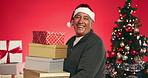 Christmas, gift and face of old man in studio for happy, holiday season and festive celebration. Boxes, xmas present and December break with elderly person on red background for tradition and smile