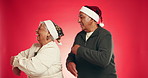 Christmas, dance and senior couple in studio with decor for holiday or festive season. Happy, marriage and mature man and woman hug with love, fun and energy for xmas celebration on red background