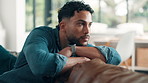 Serious, man and relax with thinking on sofa for mistake reflection, future decision and memory. Contemplating, person and thoughtful in living room with remember, perspective and planning in home
