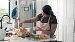 Couple, kitchen and meal prep with chicken for seasoning or thanksgiving preparation in home. Man, woman and brushing food with flavor for catering service, hospitality or cooking recipe in house