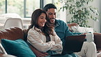 Happy couple, laptop and relax on sofa, home and talk for movie choice, coffee and hug in living room. Woman, man and computer with embrace, love and laugh with funny film on streaming subscription