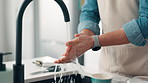 Person, water and washing hands with tap in kitchen for hygiene, disinfection or rinse in home. Closeup, chef or sink with faucet, health or safety for clean skin, bacteria or germ removal in house