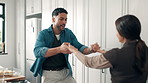 Cooking, couple or holding hands with dancing in kitchen for love, anniversary celebration or rhythm. Home, people or energy with movement, dinner date and bonding together with connection or romance