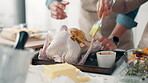 Basting, chicken and hands of couple in kitchen of home together for recipe or roast dinner. Cooking, flavor and food with people in apartment for meal preparation, nutrition or protein diet