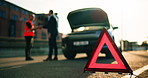 Handshake, roadside assistance and warning triangle with people outdoor for fail or mistake. Breakdown, emergency service and mechanic shaking hands with driver in city for caution, help or insurance