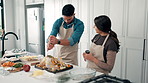 Cooking, Thanksgiving and couple in home with turkey for meal prep, dinner and festive lunch. Kitchen, talking and man with woman with ingredients, recipe and food for nutrition, dish and celebration