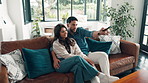 Couple, remote and watching tv with talking on sofa for movie decision, bonding and search series. Hug, people and pointing in house with film subscription, weekend break and click to change channel