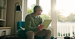 Relax, tablet and thinking with man on sofa in living room of home for entertainment or streaming. App, smile and social media review of movie with mature person in apartment to manage subscription
