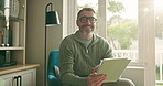 Face, smile and tablet with man on chair in living room of home for entertainment or streaming. App, relax and social media review of movie with mature person in apartment to manage subscription