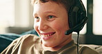 Gaming, home and child with headphones, smile and playing with subscription in living room. Happy, boy and fun with tech in house lounge, relax and kid with console, hobby and online gamer on sofa