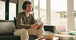 Boy, child and headset on couch with video game controller, snack and talk with online contest at home. Kid, gamer and microphone with popcorn, challenge or chat with esports on sofa in living room