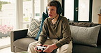 Home, video game and boy on sofa, talking and entertainment with snack, console and hobby. Apartment, kid and child on couch, headset and gamer with controller, conversation and relax with tech