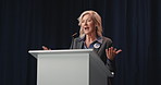 Mature woman, talk and podium for election, campaign and greeting with mic on stage for political party. Person, happy and politician with motivation, speech and call to action for vote at convention