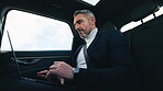 Business, man and typing on laptop in car for research, reading email and schedule meeting. Mature person, travel and vehicle with pc for company news, agenda update and information to check proposal