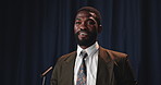 Talking, black man and politician on a stage for election, democracy or political campaign. Speech, microphone and African male speaker at conference, meeting or seminar for vote for activism.