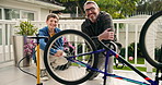 Bicycle, face or repair with father and son on patio of home for hobby or maintenance. Bike, fixing or teamwork with happy boy child and smile of single parent man outdoor in backyard of apartment