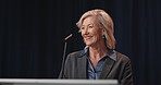 Talking, woman and politician on stage for election, microphone and meeting with speech. Mature person, presentation and speaker with mic, democracy or campaign for solution, conference or convention